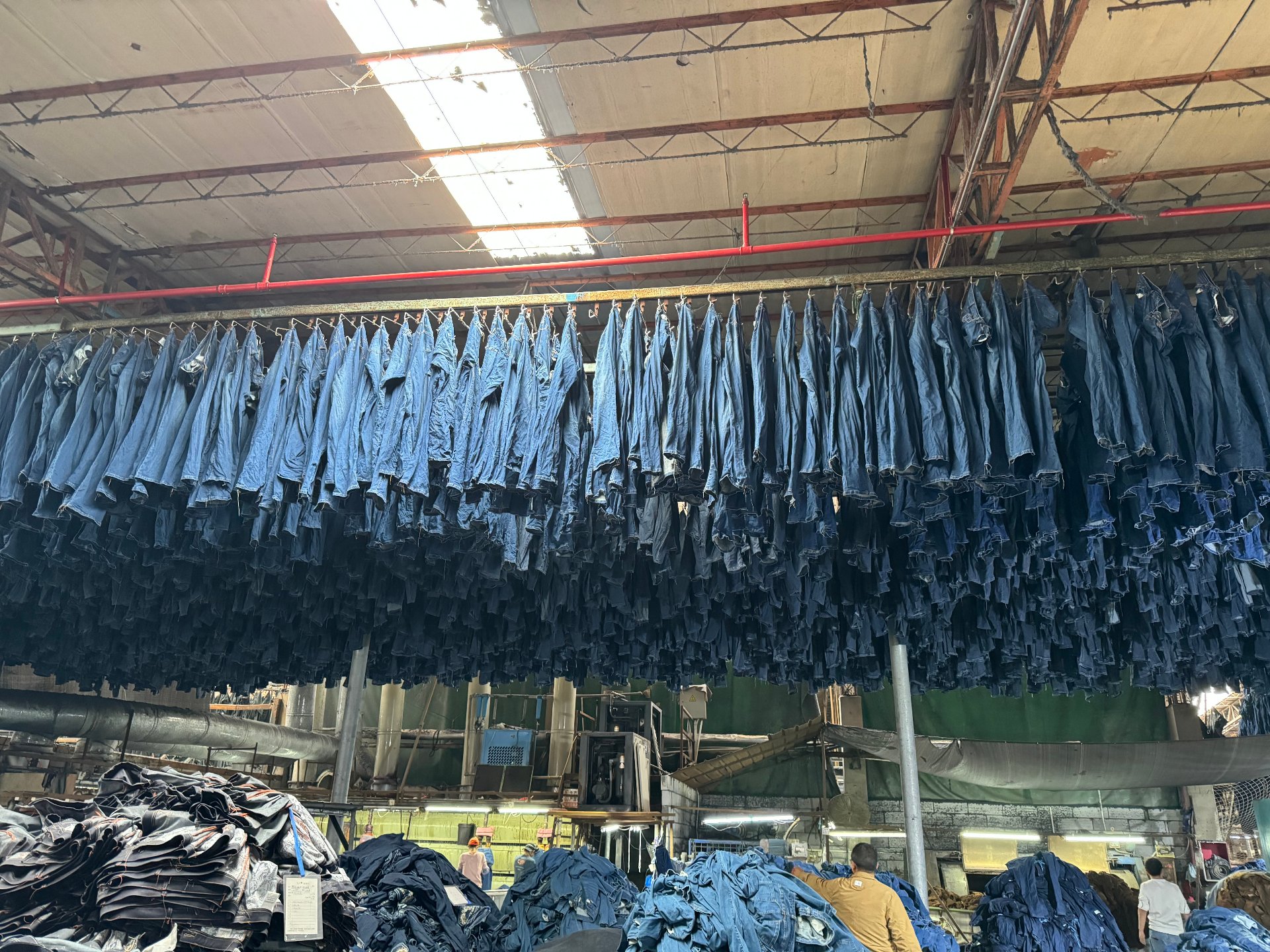 Finished garments hanging in the OnesGolden workshop