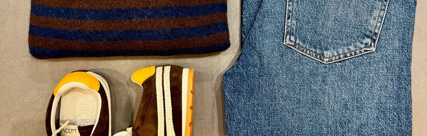 Atelier flat-lay — knitwear, vintage denim and suede sneakers